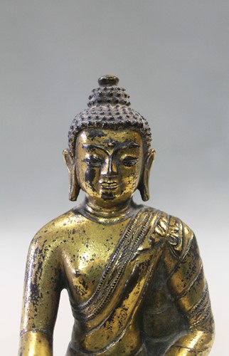 Lot 187 - A 19th century Tibetan gilt bronze model of Buddha