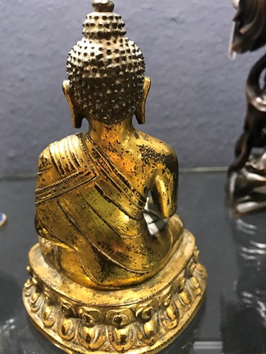 Lot 187 - A 19th century Tibetan gilt bronze model of Buddha