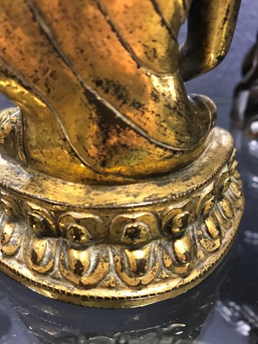 Lot 187 - A 19th century Tibetan gilt bronze model of Buddha