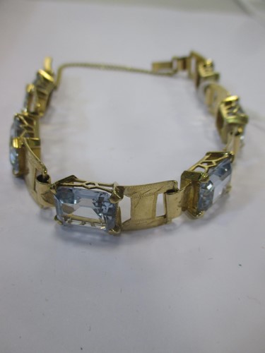 Lot 141 - A link bracelet set with blue stones and...