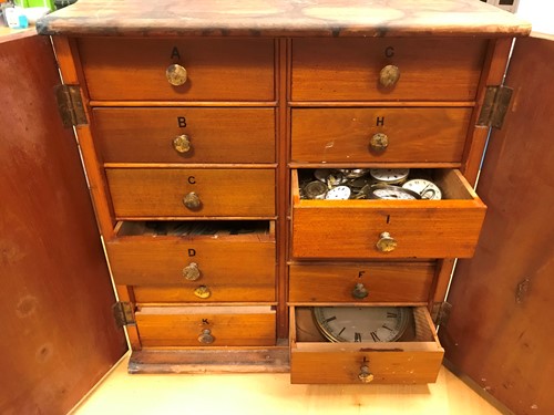 Lot 54 - A cabinet of watchmaker's spare parts, watch...