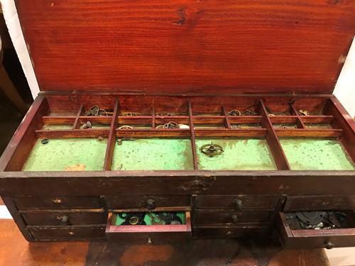 Lot 54 - A cabinet of watchmaker's spare parts, watch...