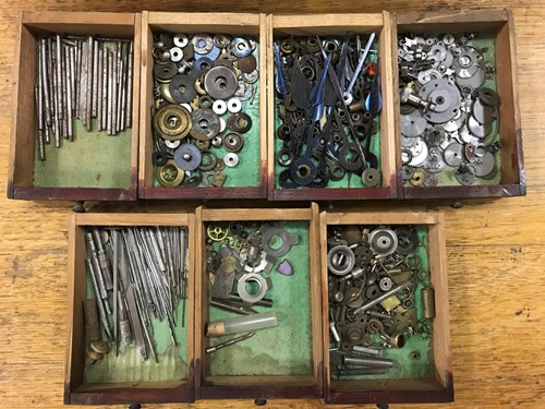Lot 54 - A cabinet of watchmaker's spare parts, watch...