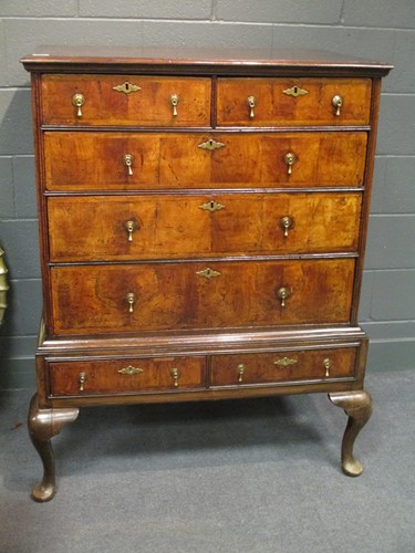 Lot 514 - An 18th century walnut chest of drawers, on a...