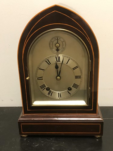 Lot 48 - An Edwardian mahogany and boxwood strung lancet top mantel clock