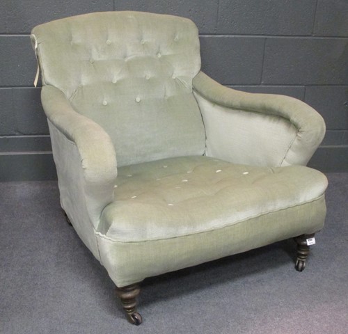 Lot 519 - A Howard & Son style armchair with button back,...