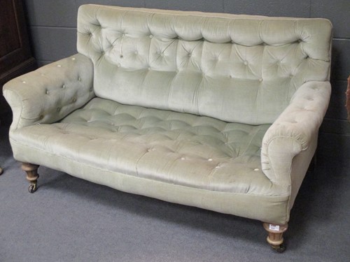 Lot 520 - A squat back two seater sofa, with button back,...