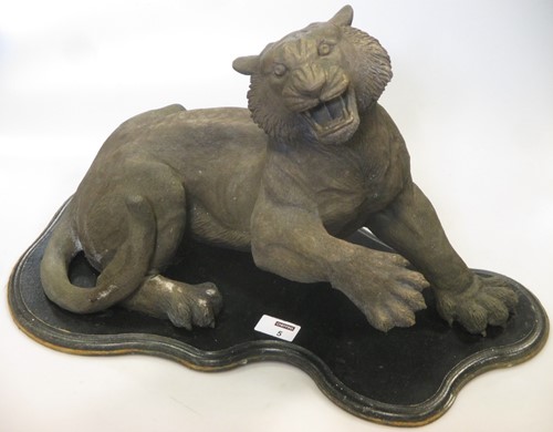 Lot 79 - A cast resin bronzed study of a wild cat on...