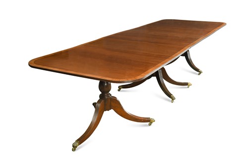 Lot 559 - A mahogany three pedestal dining table in the Regency style, 20th Century