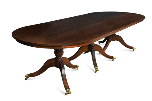 Lot 546 - A mahogany three pedestal dining table with one piece top