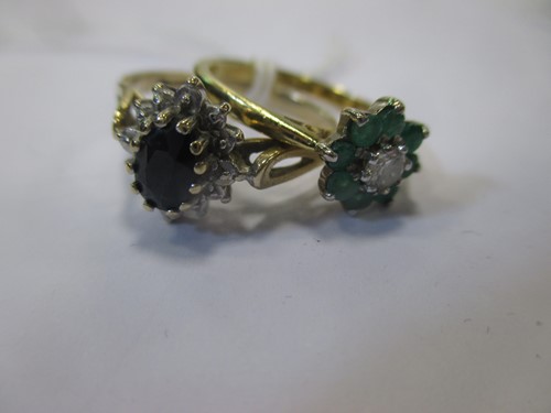 Lot 145 - An emerald and diamond cluster ring together...