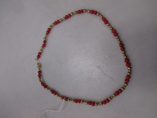 Lot 121 - A necklace of coral and gold coloured beads,...