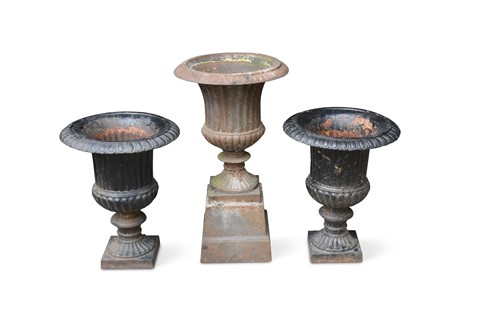 Lot 640 - A pair of cast iron Campagna style urns together with associated stands