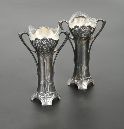 Lot 146 - A pair of WMF Art Nouveau glass lined electroplate spill vases