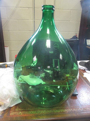 Lot 489 - Four green glass brewing bottles, 64cm high (4)