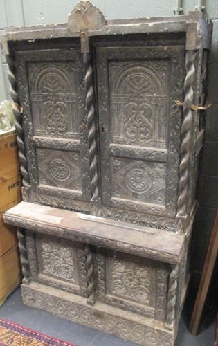 Lot 500 - A Tudor revival oak cabinet, profusely carved,...