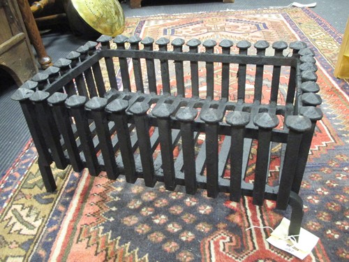 Lot 557 - A cast iron fire basket