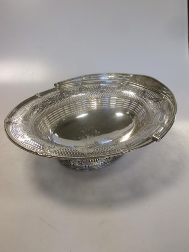 Lot 256 - A Victorian silver swing handled and pierced...