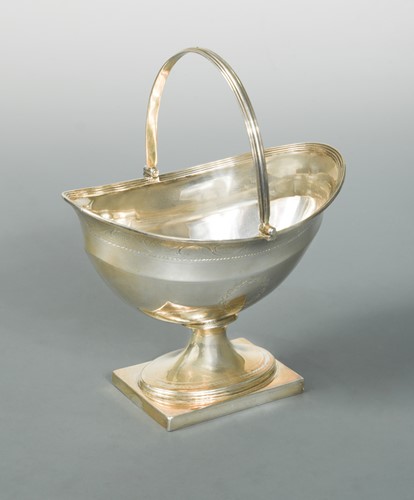 Lot 480 - A George III silver swing handled sugar basket by Henry Chawner & John Eames