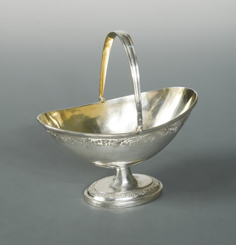 Lot 571 - A Victorian silver swing handled sugar basket