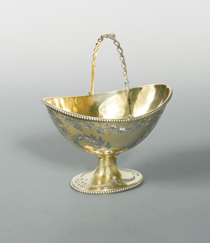 Lot 572 - A Victorian silver gilt swing handled sugar basket