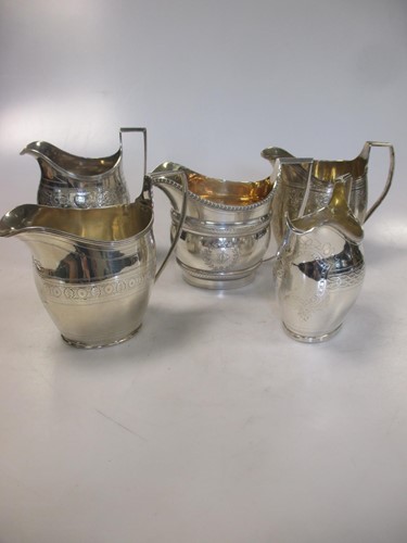 Lot 248 - A collection of five silver milk jugs, 23.2ozt...