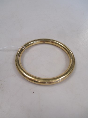 Lot 150 - A slave bangle, tests to 18ct 30.7g