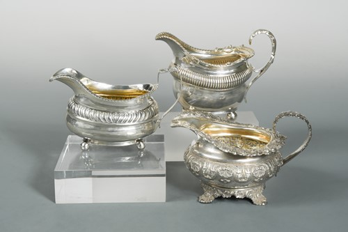 Lot 525 - A collection of three Georgian silver cream jugs by Emes & Barnard