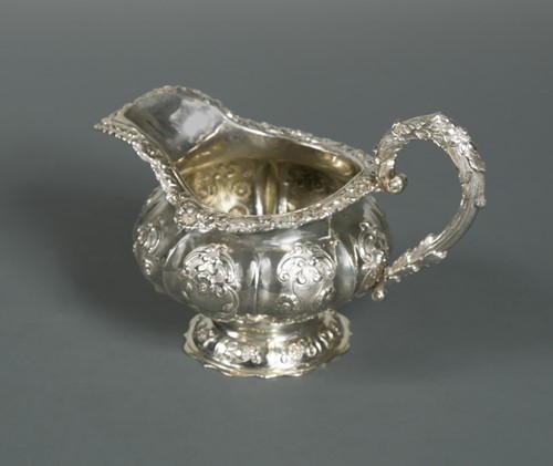 Lot 543 - A William IV silver cream jug