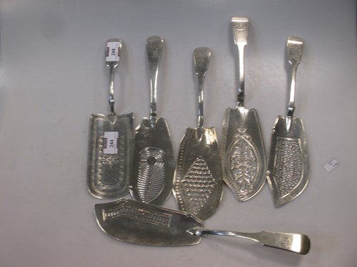 Lot 244 - Five George III silver fish servers together...