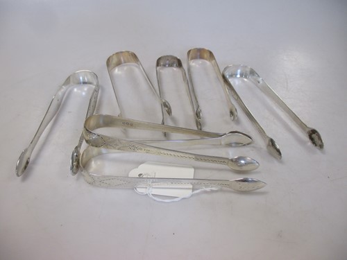 Lot 243 - A collection of 7 pairs of silver sugar nips,...