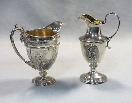 Lot 547 - Two Victorian silver helmet style cream jugs