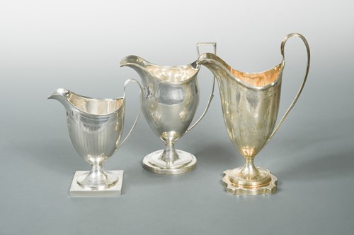 Lot 520 - A trio of 18th Century George III silver helmet style cream jugs
