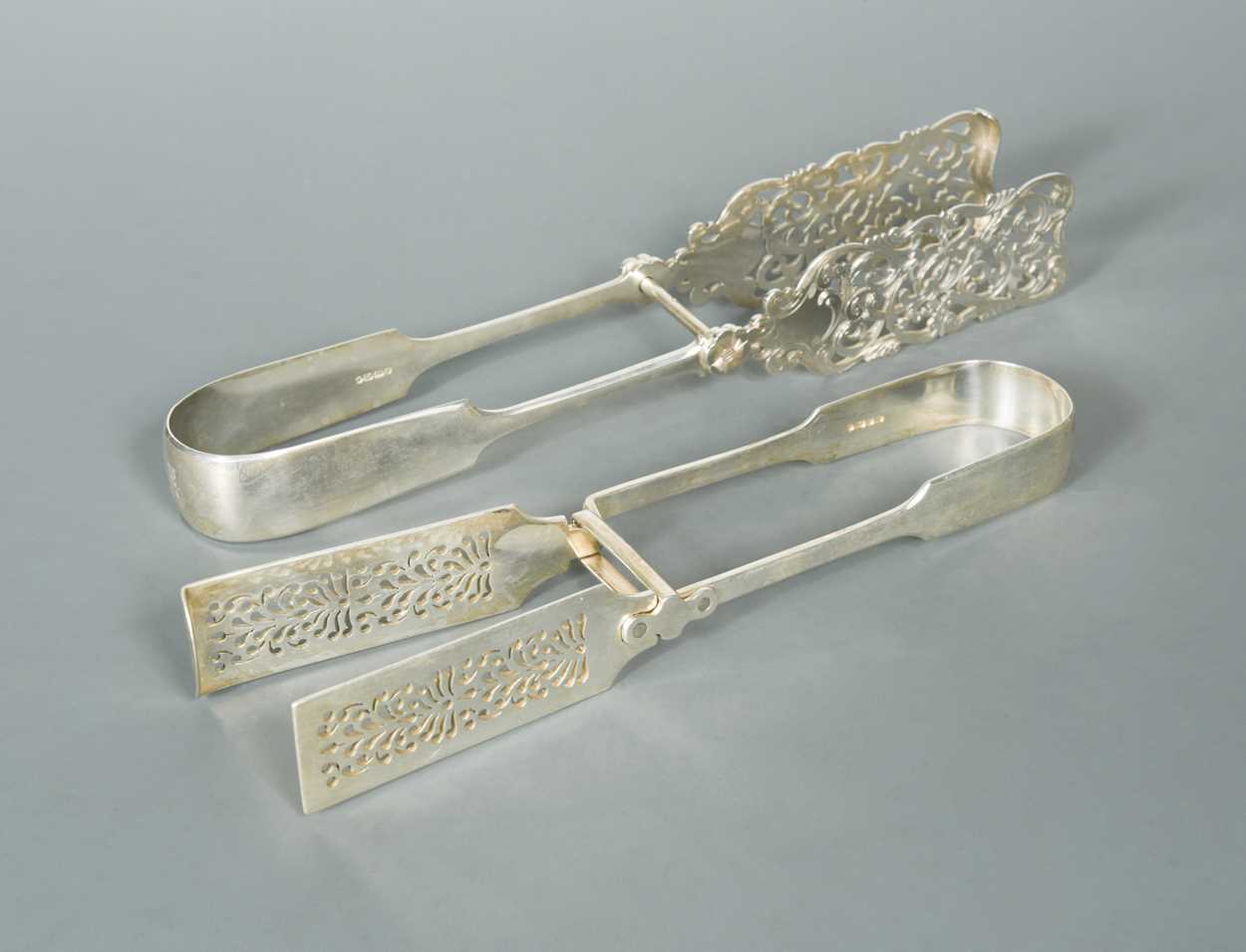 Lot 552 - Two pairs of Victorian silver asparagus tongs
