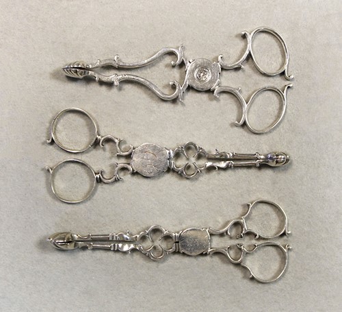 Lot 338 - Three pairs of George III 18th century silver tea tongs