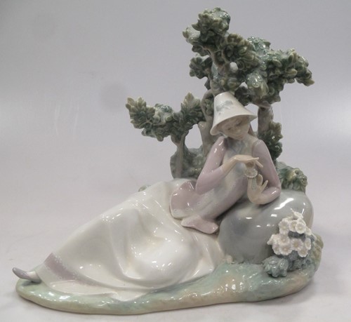 Lot 12 - A Lladro figure of a lady reclining besides a...