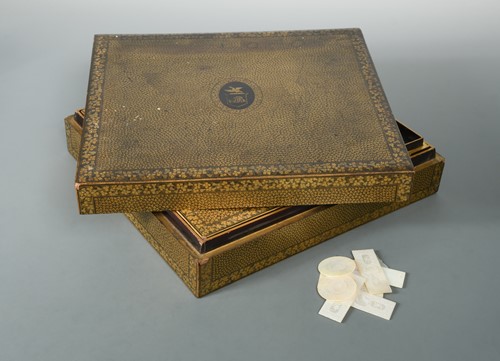 Lot 17 - A Chinese export black and gold lacquer games box, 19th century