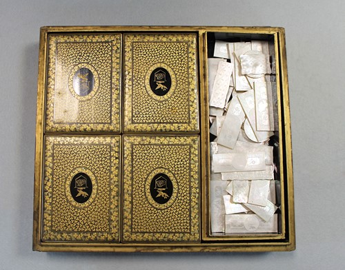 Lot 17 - A Chinese export black and gold lacquer games box, 19th century