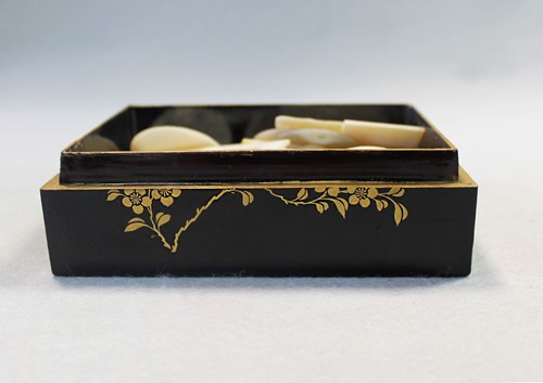 Lot 17 - A Chinese export black and gold lacquer games box, 19th century