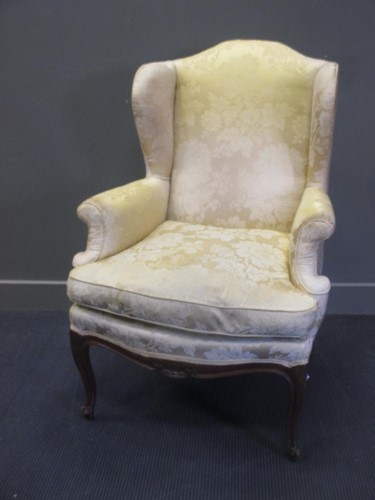 Lot 408 - A French wing armchair on cabriole legs
