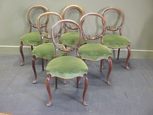 Lot 468 - A set of six Victorian walnut balloon back chairs