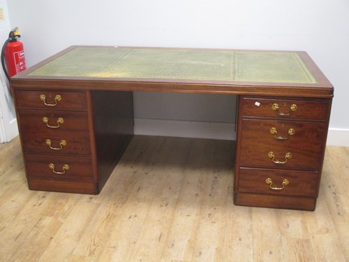 Lot 483 - A mahogany twin pedestal desk