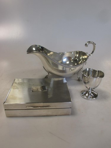 Lot 259 - A silver sauce boat, a silver egg cup and a...