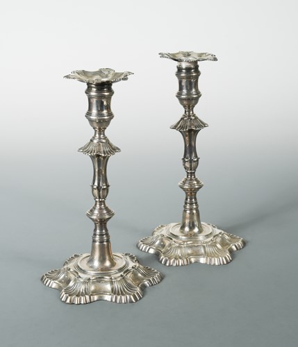 Lot 522 - A pair of early George III silver cast candlesticks by Ebenezer Coker