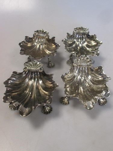 Lot 212 - A set of four George II silver shell salts,...