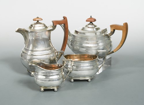 Lot 607 - A George VI silver three piece tea set with one addition