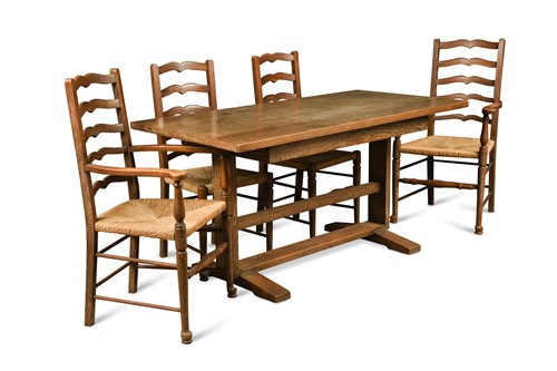 Lot 151 - Attributed to Heal's, a limed oak Cottage style refectory dining table and four chairs