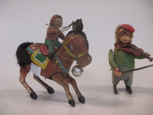 Lot 131 - A Schuco tinplate clockwork monkey violinist...