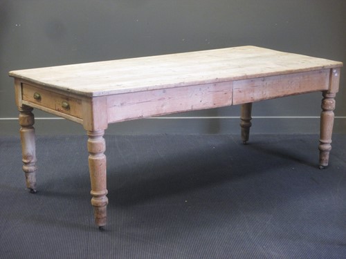 Lot 458 - A pine farmhouse kitchen table with two end...