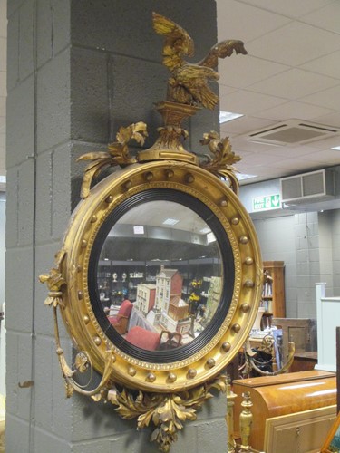 Lot 503 - A Regency giltwood convex wall mirror, with...